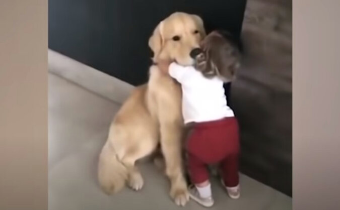 Little girl and a pup. Source: YouTube screenshot